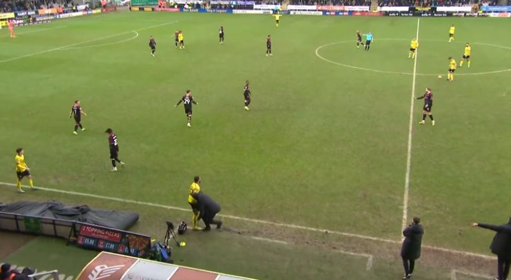 Burton's manager knocked the ball away after it slipped on the touchline.